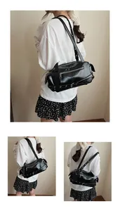 Detail of black PU shoulder bag featuring punk metal zippers, buckles and rivets