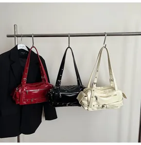 Detailed view of fashionable faux leather baguette bags with punk eyelets and buckles