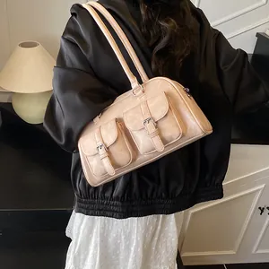 Minimalist beige PU leather bowling bag for women with dual buckled front pockets