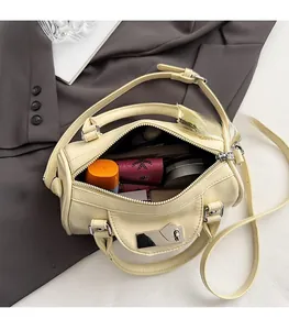 Detail view of mini pillow bag interior showing ample storage for cosmetics and essentials