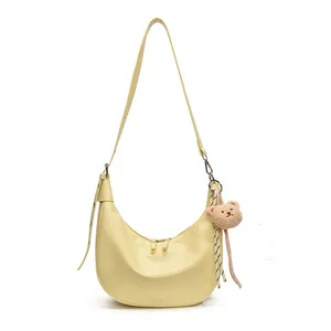 Minimalist pale yellow crocodile pattern crescent underarm bag with cute bear charm
