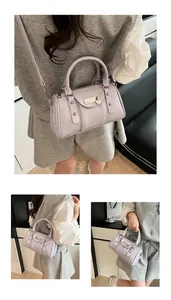 Detail of lavender Boston bag featuring heart padlock, silver studs and shiny finish