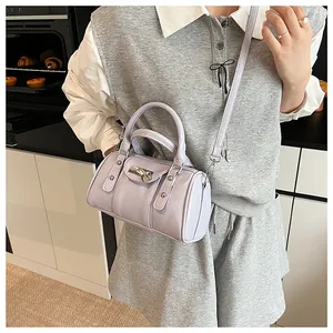 Detail of light purple pillow bag with silver rivets and heart-shaped metal lock