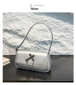Silver gothic shoulder bag with cross ornament, chain decor and black rivet details