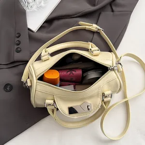 Creamy yellow boston pillow bag with silver heart lock and adjustable shoulder strap