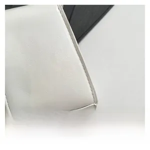 Close-up of white leather texture and precise stitching on the luxury handbag