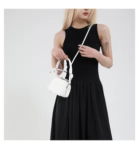 Detail of white PU leather mini box bag with silver buckle and fine stitching details