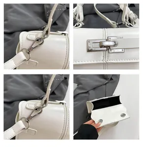 Detail of white leather handbag showing silver magnetic buckles and polished texture