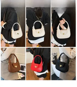 Model showcasing four colors of textured crescent bags with gold hardware details