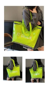 Detail of neon green jelly tote bag with IT CHICK print and transparent PVC outer layer