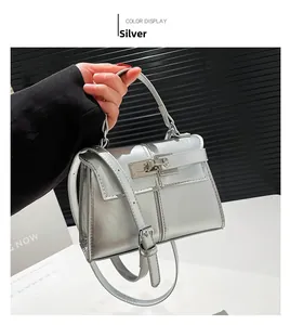 Macro detail of silver trapezoid handbag with metallic finish and iconic turn-lock closure