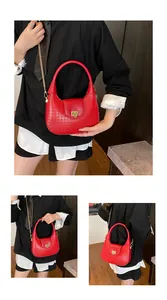 Detail of red woven texture crescent bag with gold chain strap and metal lock buckle