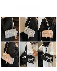 Detailed views of stylish underarm bag with large ribbon bow in grey, pink, and black