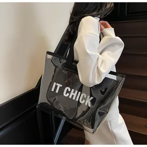 Close-up of a large transparent jelly tote bag with IT CHICK logo and inner pouch