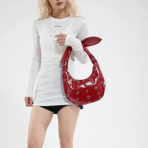Red glossy hobo handbag with silver eyelet studs and creative rabbit ear knot handle