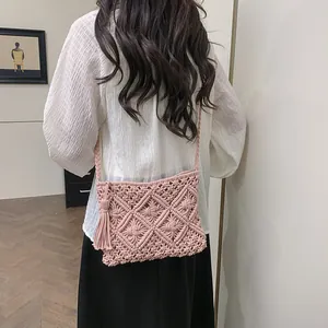 Bohemian pink macrame crossbody bag with woven diamond patterns and long tassel detail