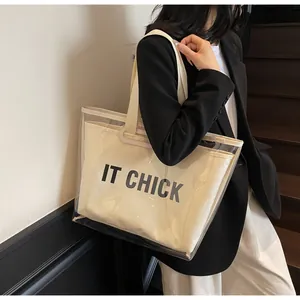 Detail of transparent PVC tote bag featuring canvas inner pouch with IT CHICK print