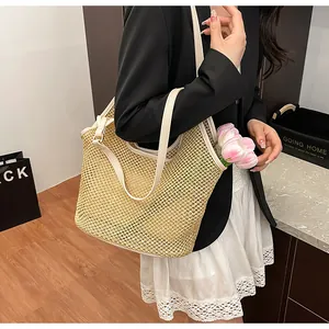 Detailed texture of hollow woven straw tote bag with white faux leather trim for summer