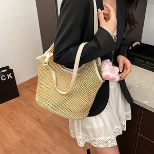 Fashionable woven straw tote bag with cream leather straps for summer beach vacations