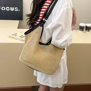 Chic beige woven straw tote bag with black leather straps for summer beach vacation style