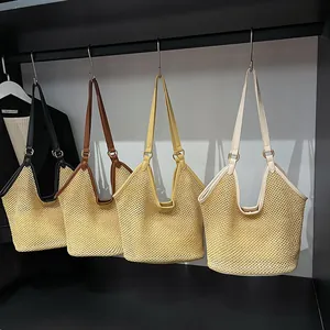 Handcrafted woven straw tote bags in black, brown, and beige with leather straps