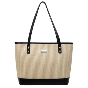 Chic beige straw tote bag with black leather straps and silver metal logo plate