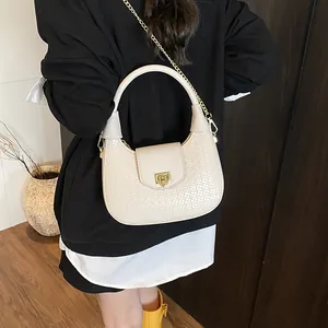 Chic cream crescent shoulder bag with woven texture and gold chain strap for women