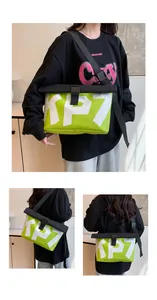 Detail of neon green messenger bag with white KP7 print and roll-top buckle closure