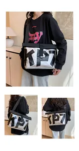 Silver metallic messenger bag with KP7 print and roll-top buckle closure shown on model