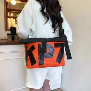 Outdoor cycling messenger bag in orange and black with KP7 lettering and buckle