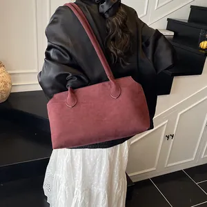 Minimalist burgundy suede tote bag for women shown on model for a stylish casual look