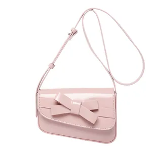 Pink patent leather crossbody bag with large bow decoration for women's stylish daily use