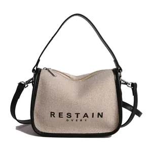 Minimalist knit fabric crossbody bag with black trim and RESTAIN GVERY logo print