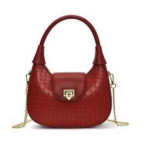 Red crescent woven bag for women featuring gold chain strap and metal clasp on white background