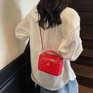 Quilted red vanity case bag with camellia metal clasp and leather chain strap for women