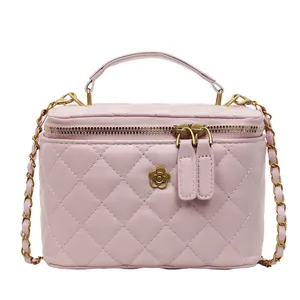Pink quilted crossbody bag with golden flower detail and elegant chain strap for women