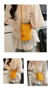 Detail of yellow pebbled leather mini bag featuring unique round knot decorative accent