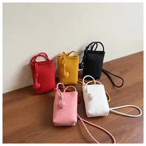 Detailed shot of five mini crossbody phone bags in various colors with litchi grain texture
