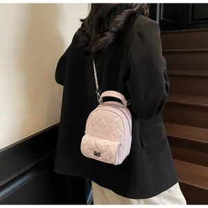 Pink quilted mini backpack with rhinestone embellishments on a model for daily use