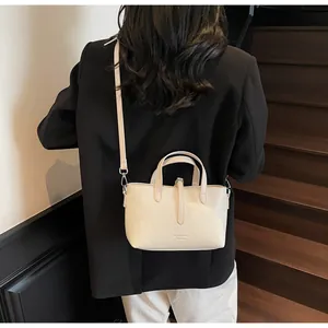 Detail of off-white lychee texture leather tote bag with elegant fashion engraving