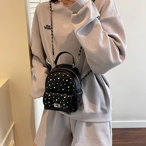 Mini black quilted leather backpack with silver studs and chain strap for women