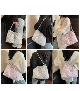 Quilted bucket bags in white and lilac with star metal details and rivet accents