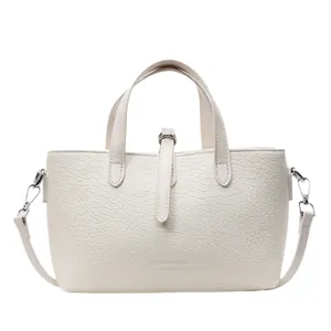 Minimalist cream faux leather tote bag with pebble texture and detachable shoulder strap