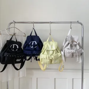Minimalist canvas campus backpacks with D-print in black, navy, yellow, and grey colors