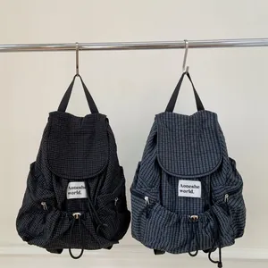 Large plaid backpack with drawstring closure in black and blue colors for casual use