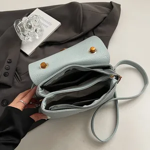 Light blue lychee pattern leather crossbody bag with multiple inner compartments and gold hardware