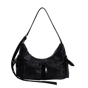 Black crescent moon shoulder bag with functional zippered pockets and adjustable strap
