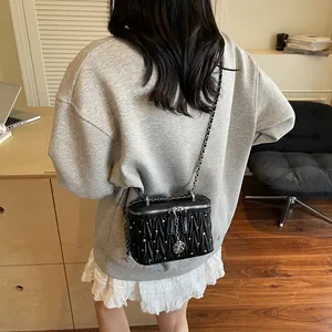 Elegant black quilted crossbody bag with sparkling rhinestones and silver chain strap
