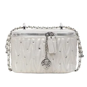 Elegant white quilted crossbody bag with pearl sheen and silver rose zipper detail