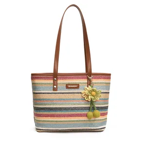 Rainbow striped woven straw tote bag with brown leather straps and floral charm